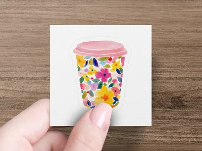 Pink lid coffee cup with colorful floral pattern.