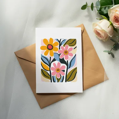 Card with colorful abstract flowers and leaves on brown envelope.