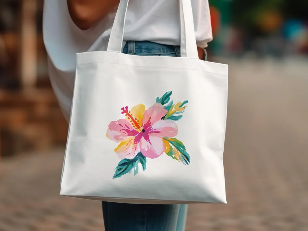 White tote bag with a colorful hibiscus flower illustration.