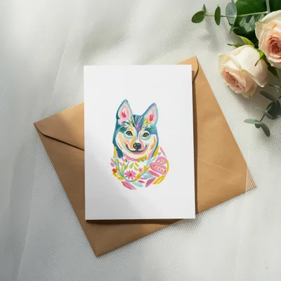 Card with colorful abstract husky illustration on brown envelope.