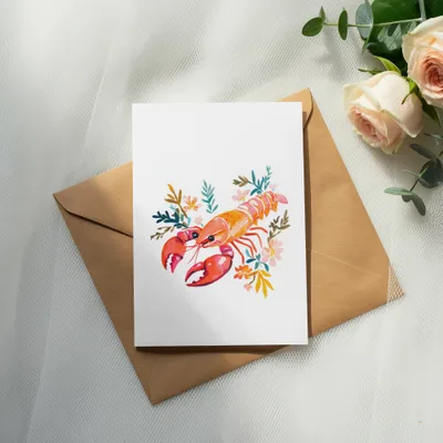 Watercolor lobster illustration with flowers on a card and envelope.