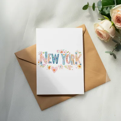 Greeting card with "New York" in colorful floral lettering on an envelope.