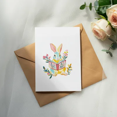 Illustration of a cartoon rabbit reading a book, surrounded by flowers.