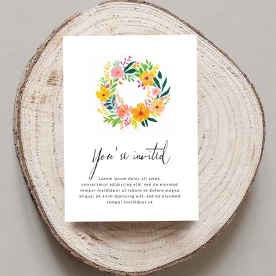 Invitation with floral wreath and "You're invited" text.