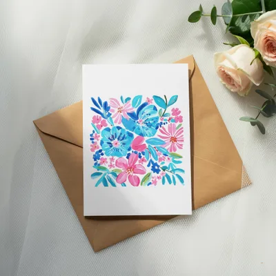 Watercolor floral greeting card on brown envelope, with roses and eucalyptus.