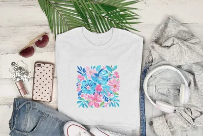 White t-shirt with a floral pattern featuring pink and blue flowers.