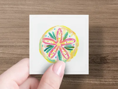 Hand holds square card with colorful, abstract floral drawing.