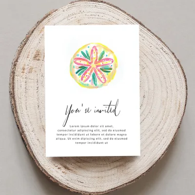 Invitation card with "You're invited" text and watercolor citrus slice.