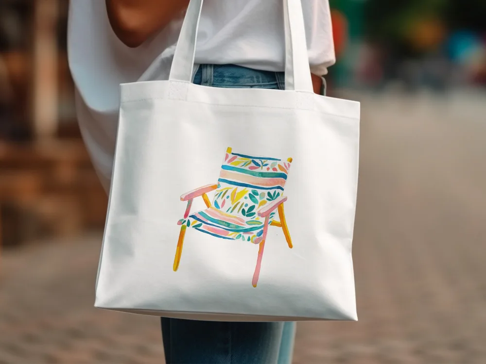 White tote bag with colorful striped beach chair illustration.
