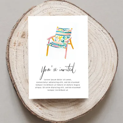 Invitation card with watercolor beach chair and "You're invited" text.