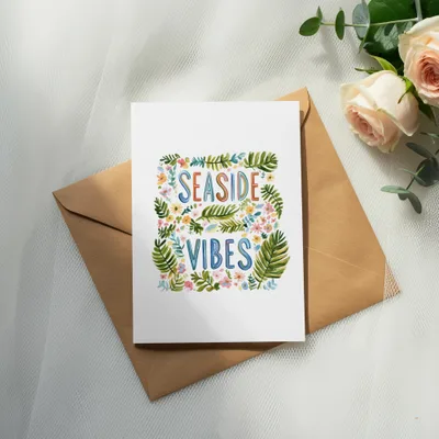 Card with "SEASIDE VIBES" text surrounded by colorful leaves and flowers.