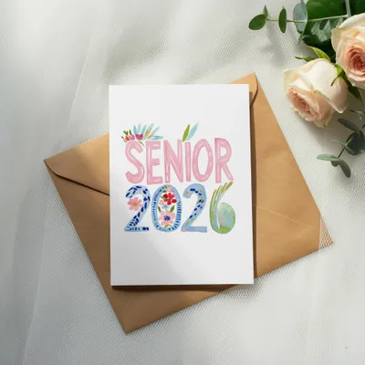 Senior 2026 card with floral and globe design on brown envelope.