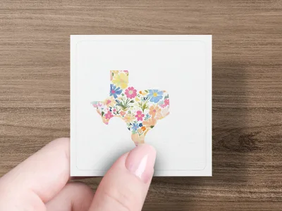 Texas outline filled with colorful watercolor flowers on a white card.