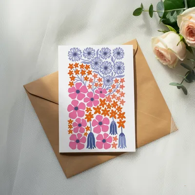 Card with pink, orange, and purple floral designs on a brown envelope.