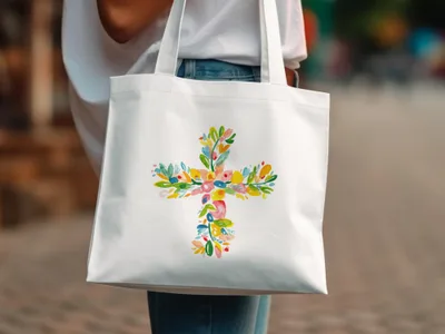White tote bag with a colorful floral cross design.