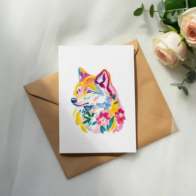 Watercolor wolf portrait on a card with flowers, on a brown envelope.