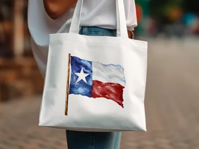White tote bag with a watercolor Texas flag design.