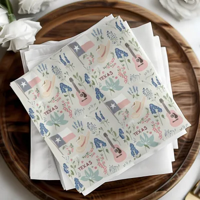 Fabric napkin with Texas motifs: flag, boot, guitar, and state outline.