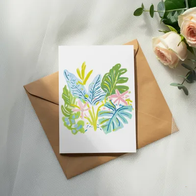 Card with colorful tropical leaves and flowers on a brown envelope.