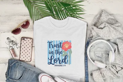 White t-shirt with "Trust in the Lord" text and floral graphic.