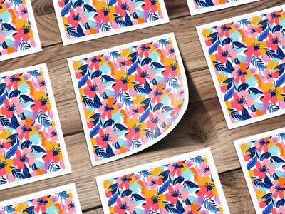 Floral pattern on white cards scattered on a wooden surface.
