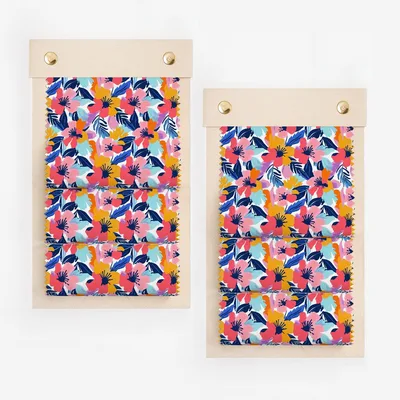 Two fabric swatches with a vibrant floral pattern of pink, blue, and yellow flowers.