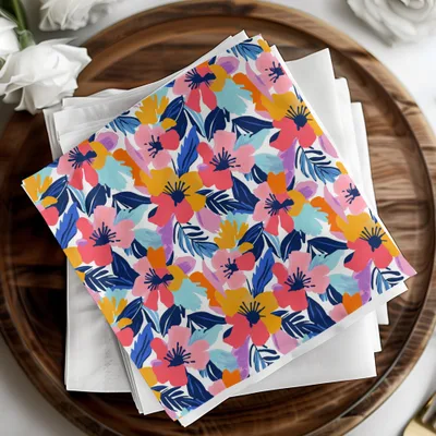 Colorful floral pattern fabric napkin set on a wooden tray.