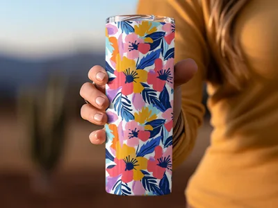 Woman holding a colorful floral patterned tumbler cup.