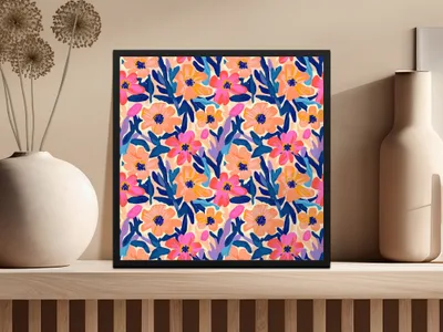 Colorful floral pattern artwork in a black frame on a shelf.