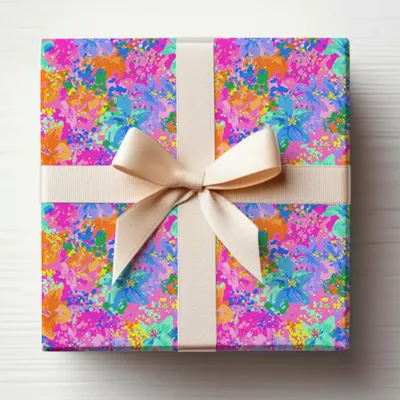 Gift-wrapped box with floral pattern and beige ribbon bow.