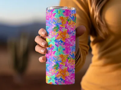 Woman's hand holds a pink tumbler with a vibrant floral pattern.