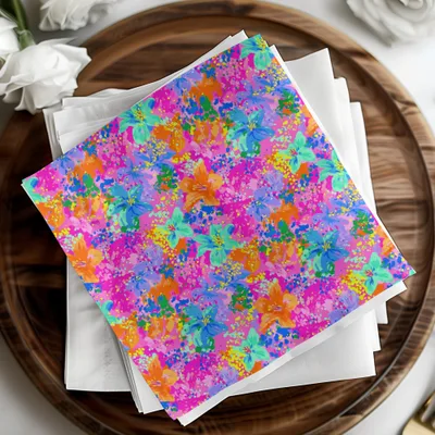 Paper cocktail napkins with colorful floral and splatter print on white napkins.