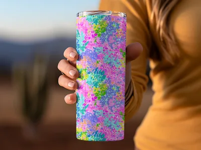 Person holding a colorful floral patterned tumbler.