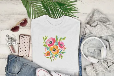 White t-shirt with colorful floral print, laid flat with accessories.