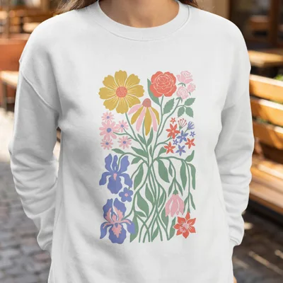 White sweatshirt with a colorful floral illustration.