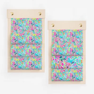 Two fabric swatch displays with vibrant pink, blue, and green abstract floral patterns.