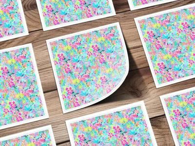 Floral pattern cards spread on a wooden surface, one card is bent.