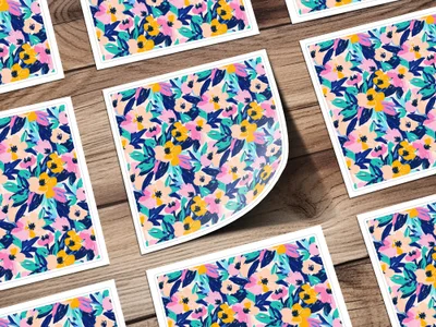 Floral patterned stickers with pink, yellow, and blue flowers on a wooden surface.