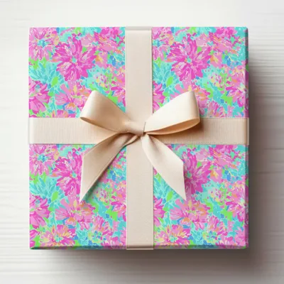 Gift-wrapped present with a floral pattern and a cream ribbon.