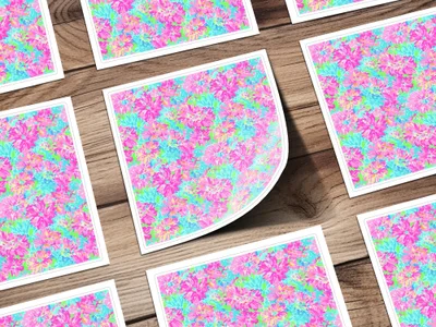 Floral pattern stickers with pink, blue, and green flowers on a wooden surface.