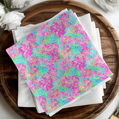 Stack of napkins with bright pink, blue, and green floral pattern.