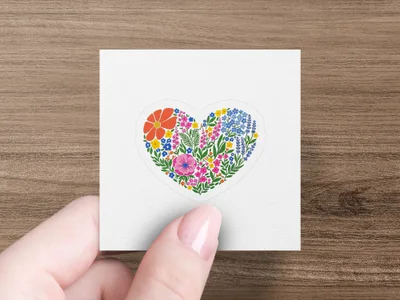 Heart-shaped sticker with colorful flowers and greenery.