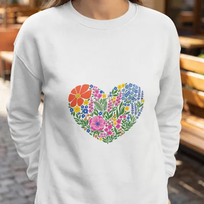 White sweatshirt with a vibrant heart-shaped floral design.
