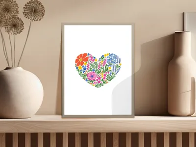 Heart-shaped floral arrangement with colorful flowers on a light gray background.