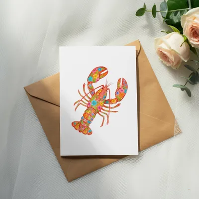 Colorful floral lobster illustration on white card, resting on brown envelope.