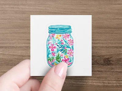 Blue mason jar filled with vibrant pink and teal floral design.