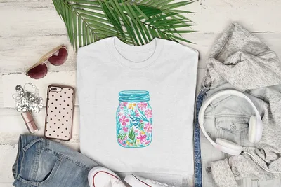 White t-shirt with colorful floral mason jar graphic.