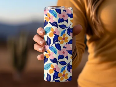 Floral print tumbler with blue, pink, and orange flowers on a cream background.