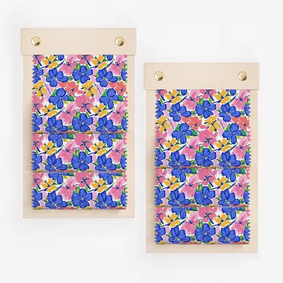 Two fabric swatches with a blue, pink, and yellow floral pattern on a white background.