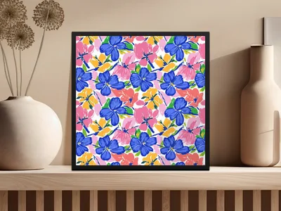 Framed artwork with a colorful floral pattern on a shelf.